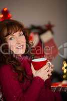 Portrait of pretty redhead enjoying hot drink