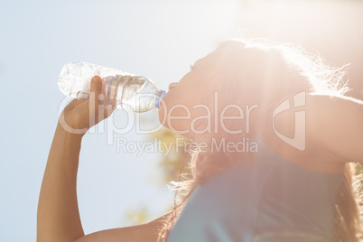 Fit blonde drinking from her water bottle