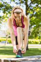 Fit blonde tying her shoelace