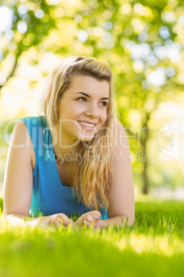 Fit blonde lying on the grass