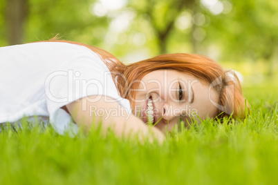 Portrait of a pretty redhead happy and lying