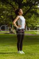 Side view of healthy woman standing in park