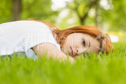 Portrait of a pretty redhead calm and lying
