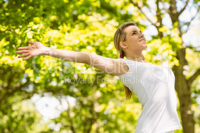 Peaceful blonde doing yoga in the park