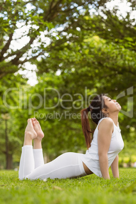 Healthy woman doing stretching exercises at park