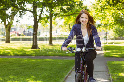 Pretty redhead cycling a bike