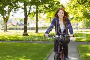 Pretty redhead cycling a bike