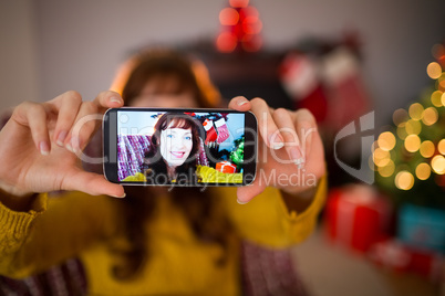 Smiling redhead taking a selfie at christmas