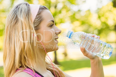 Fit blonde drinking from her water bottle