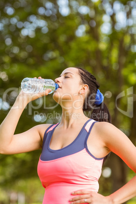 Fit brown hair drinking from her water bottle