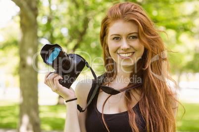 Beautiful female photographer at park