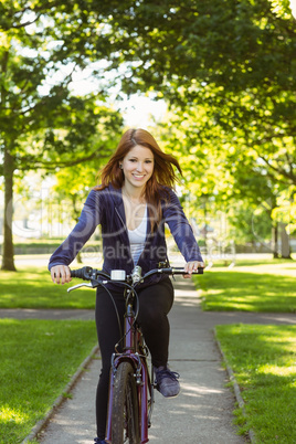 Pretty redhead cycling a bike