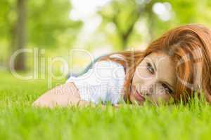 Portrait of a pretty redhead thoughtful and lying