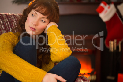 Pretty redhead in day dreaming at christmas