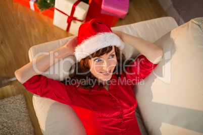 Redhead in santa hat relaxing on the couch at christmas