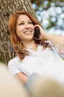 Pretty redhead smiling on the phone