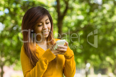 Woman text messaging in park