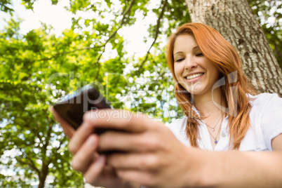 Pretty redhead text messaging on her phone