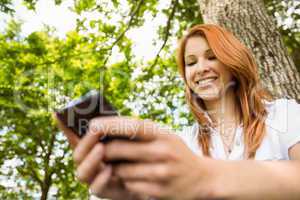 Pretty redhead text messaging on her phone