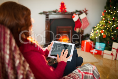 Redhead touching digital tablet at christmas