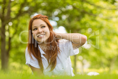 Portrait of a pretty redhead smiling and lying