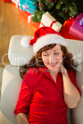 Relaxed redhead lying on the sofa at christmas