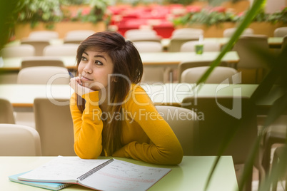 College student doing homework in canteen