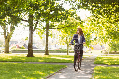 Pretty redhead cycling a bike