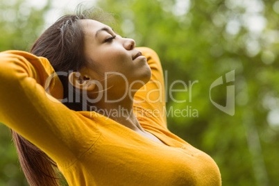 Beautiful woman with eyes closed in park