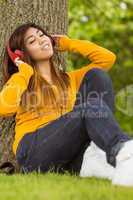 Relaxed woman enjoying music in park