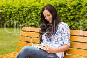 Happy brunette reading a book