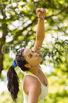Concentrated fit brunette stretching in the park