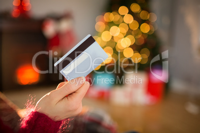 Woman holding credit card at christmas