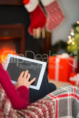 Red hair touching digital tablet at christmas