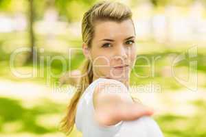 Peaceful blonde doing yoga in the park