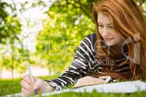 Female student doing homework in park