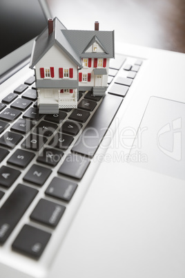 Miniature House on Laptop Computer