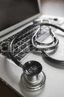 Medical Stethoscope Resting on Laptop Computer