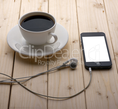 headphones and a cup of coffee