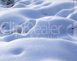 Snow drifts in snowbound winter meadow