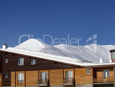 Hotel in snow at winter mountains