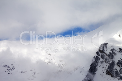 View on off-piste slope in clouds