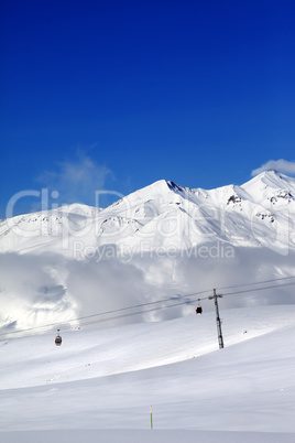 Winter snowy mountains and cable car at nice day