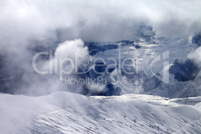 Off-piste slope in sunlight clouds