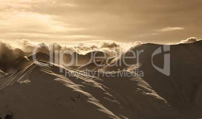 Sepia mountains in mist at sun evening