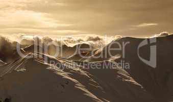 Sepia mountains in mist at sun evening