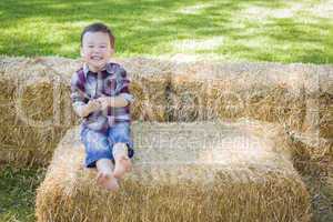 Cute Young Mixed Race Boy Having Fun on Hay Bale