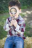Cute Young Mixed Race Boy Looking Through Magnifying Glass