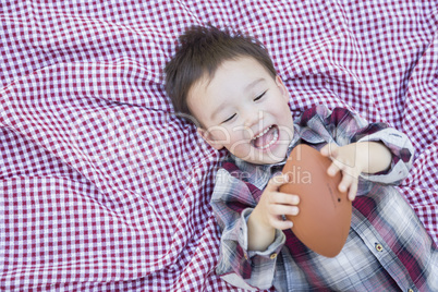 Young Mixed Race Boy Playing with Football on Picnic Blanket