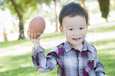 Cute Young Mixed Race Boy Playing Football Outside